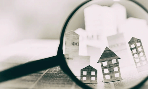 magnifying glass looking at houses